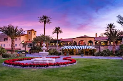a fountain in the middle of a yard with palm trees at The Inn at Death Valley in Death Valley