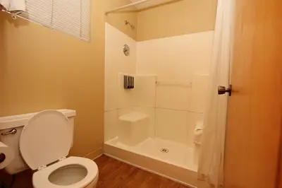 a bathroom with a toilet and a shower at Oakhurst Lodge in Oakhurst