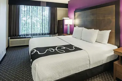 a hotel room with a large bed and a window at La Quinta by Wyndham Rancho Cordova Sacramento in Rancho Cordova