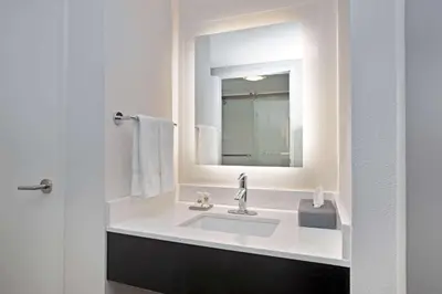 a bathroom with a sink and a mirror at La Quinta by Wyndham Rancho Cordova Sacramento in Rancho Cordova