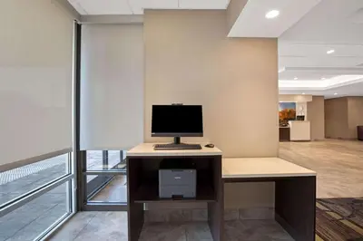an office with a desk with a computer on it at La Quinta by Wyndham Rancho Cordova Sacramento in Rancho Cordova