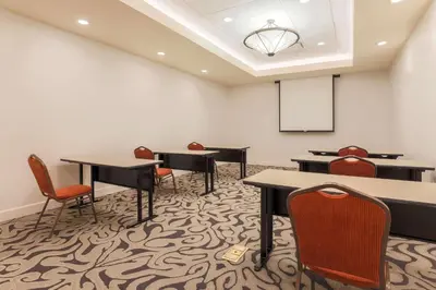 a conference room with tables and chairs and a white wall at Hilton Garden Inn Reno in Reno