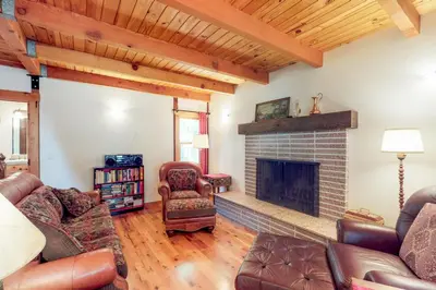 a living room with a fireplace and leather furniture at Timeless in Tahoma in Tahoma
