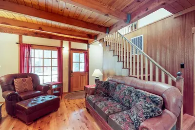 a living room with a couch and a chair at Timeless in Tahoma in Tahoma
