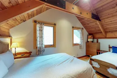 a bedroom with two beds and two windows at Timeless in Tahoma in Tahoma