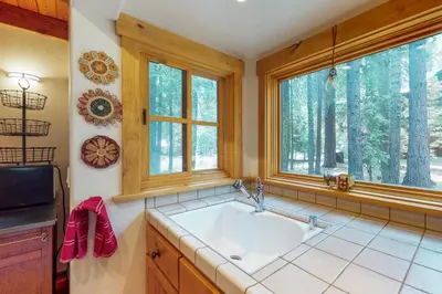 a kitchen with a sink and two windows at Timeless in Tahoma in Tahoma