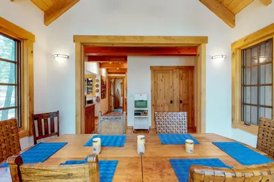 a dining room with a wooden table and chairs at Timeless in Tahoma in Tahoma
