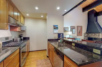 a kitchen with granite counter tops and a stove top oven at Kingswood Retreat in Kings Beach