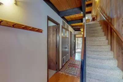 a hallway with stairs and a door with a rug at Kingswood Retreat in Kings Beach