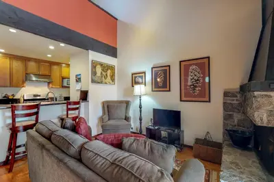 a living room with a couch and a kitchen at Kingswood Retreat in Kings Beach