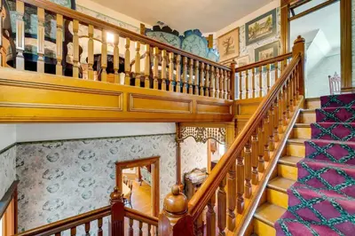 a wooden staircase with wooden railings in a house at Lodi Hill House in Lodi