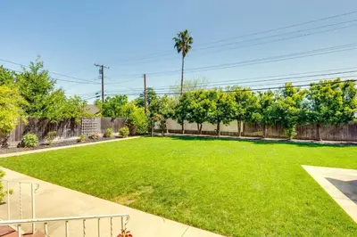 a large yard with a fence and green grass at Lodi Hill House in Lodi