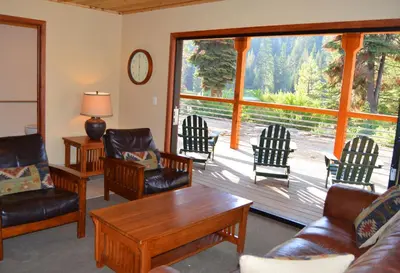 a living room with furniture and a large window at Montecito Sequoia Lodge in Sequoia National Park