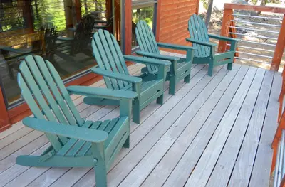 three blue rocking chairs sitting on the porch of a house at Montecito Sequoia Lodge in Sequoia National Park