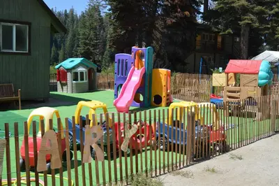 a playground with a toy train on a fence at Montecito Sequoia Lodge in Sequoia National Park