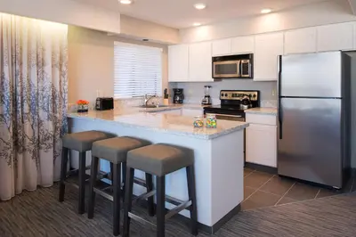a kitchen with a large island with bar stools at Hotel Azure in South Lake Tahoe