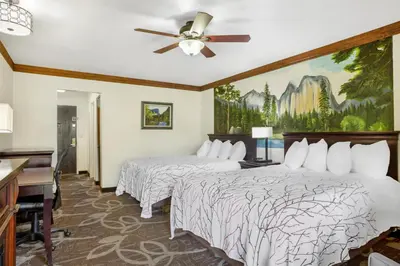 a hotel room with two beds and a ceiling fan at Best Western Plus Yosemite Gateway Inn in Oakhurst