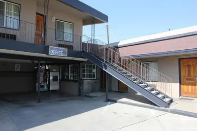 a staircase in a building with a sign on it at Garden View Inn in Fresno