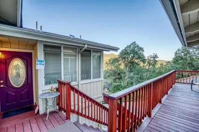 a front porch of a house with a purple door at A Bed of Roses in Yosemite Forks