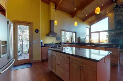 a large kitchen with wooden cabinets and a large island at Pine Mountain Getaway (02-461) in Groveland