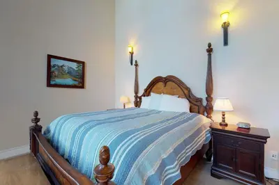 a bedroom with a bed with a blue and white bedspread at Pine Mountain Getaway (02-461) in Groveland