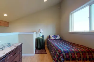 a small bedroom with a bed and a window at Pine Mountain Getaway (02-461) in Groveland