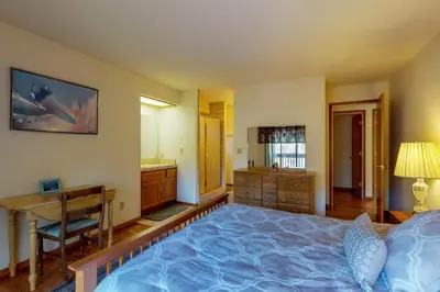 a bedroom with a large bed and a desk and a desk at Lake Lodge Beach (04-040) in Groveland
