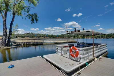 a boat is docked at a dock in the water at Lake Lodge Beach (04-040) in Groveland