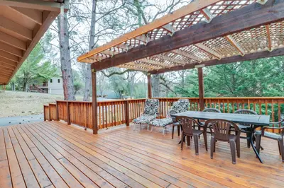a wooden deck with a table and chairs on it at Lake Lodge Beach (04-040) in Groveland