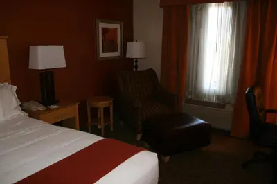 a hotel room with a bed and a chair at Holiday Inn Express Stockton Southeast by IHG in Stockton