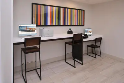 a desk with three chairs and a computer on it at Holiday Inn Express Stockton Southeast by IHG in Stockton