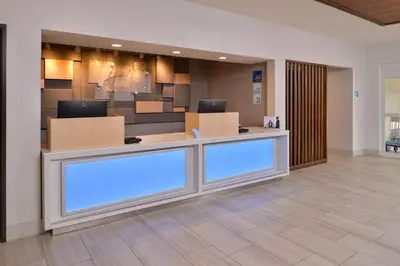 a lobby with a reception desk with blue lights at Holiday Inn Express Stockton Southeast by IHG in Stockton