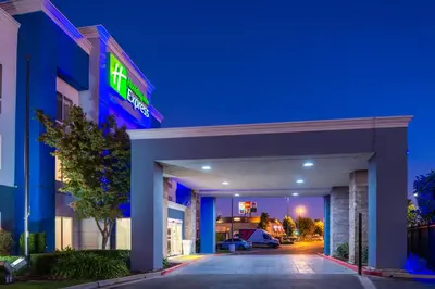 a hotel with a blue sign on the front of it at Holiday Inn Express Stockton Southeast by IHG in Stockton