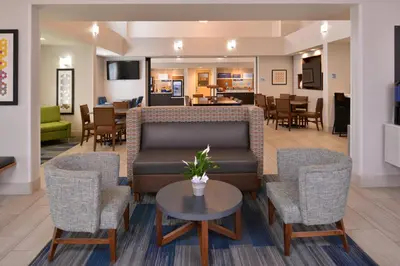 a lobby with a couch and chairs and a table at Holiday Inn Express Stockton Southeast by IHG in Stockton