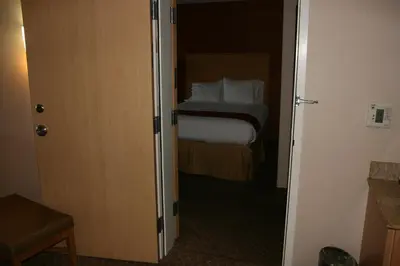 a door to a bedroom with a bed in a room at Holiday Inn Express Stockton Southeast by IHG in Stockton