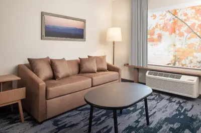a living room with a couch and a table at Fairfield Inn & Suites by Marriott Fresno North/Shaw Avenue in Fresno