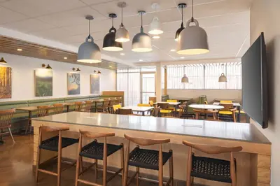 a dining area with tables and chairs in a restaurant at Fairfield Inn & Suites by Marriott Fresno North/Shaw Avenue in Fresno