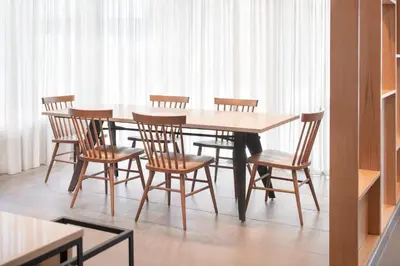 a wooden table and chairs in a room at Fairfield Inn & Suites by Marriott Fresno North/Shaw Avenue in Fresno