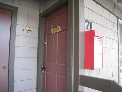 a red door on the side of a house at Sierra Manor in Mammoth Lakes