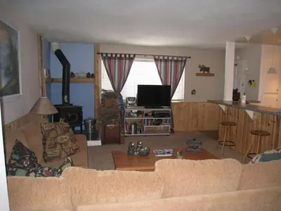 a living room with a couch and a tv at Sierra Manor in Mammoth Lakes