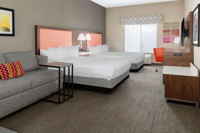 a hotel room with a bed and a couch at Hampton Inn & Suites Sacramento-Auburn Boulevard in Sacramento