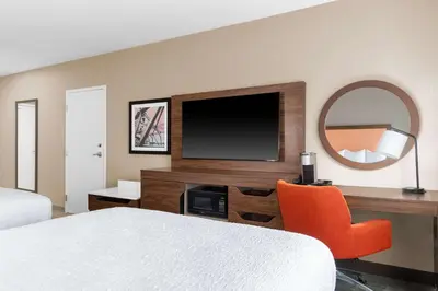 a hotel room with a tv and a bed and a mirror at Hampton Inn & Suites Sacramento-Auburn Boulevard in Sacramento