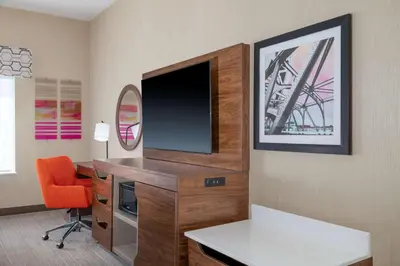 a room with a desk with a television and a chair at Hampton Inn & Suites Sacramento-Auburn Boulevard in Sacramento