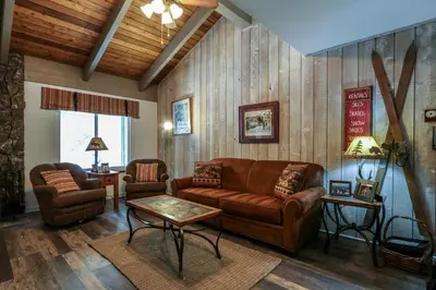 a living room with a couch and two chairs and a table at Sunshine Village 104 Condo in Mammoth Lakes