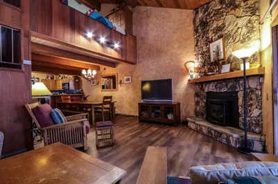 a living room with a fireplace and a television at Winterset 12 Condo in Mammoth Lakes