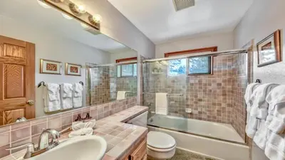 a bathroom with a sink and a tub and a toilet at Your Roomy Northstar Retreat Awaits in Truckee