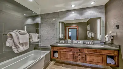 a bathroom with two sinks and a tub and a mirror at Luxury 3Br Residence Steps From Heavenly Village & Gondola Condo in South Lake Tahoe