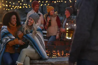 a group of people sitting on steps with lights at Luxury 3Br Residence Steps From Heavenly Village & Gondola Condo in South Lake Tahoe