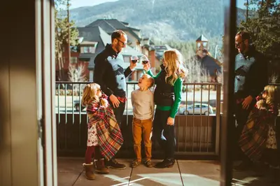 a family standing on a balcony drinking wine at Luxury 3Br Residence Steps From Heavenly Village & Gondola Condo in South Lake Tahoe
