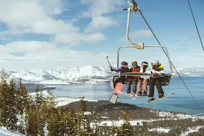 a group of four people riding a ski lift at Luxury Three Bedroom Residence Steps From Heavenly Village Condo in South Lake Tahoe